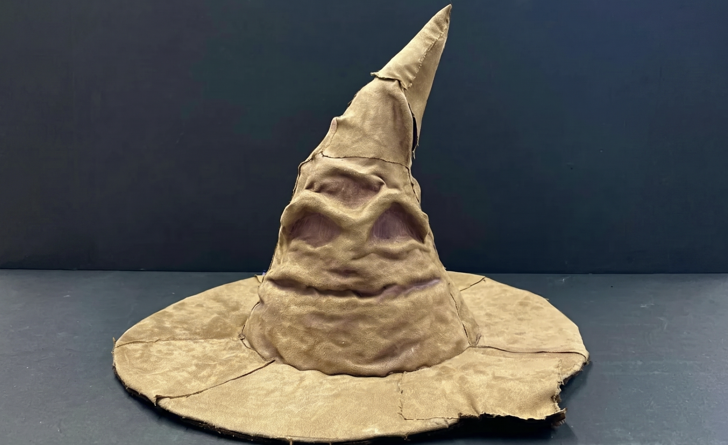 Handmade voice-interactive Hogwarts Sorting Hat on a dark background